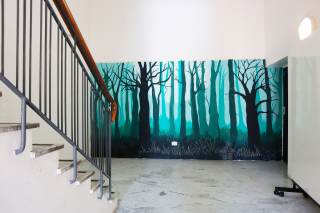 Murales Istituto Livi Brunelleschi - via Galcianese a tema naturale: bosco di notte, con alberi spogli e sfondo turchese.
